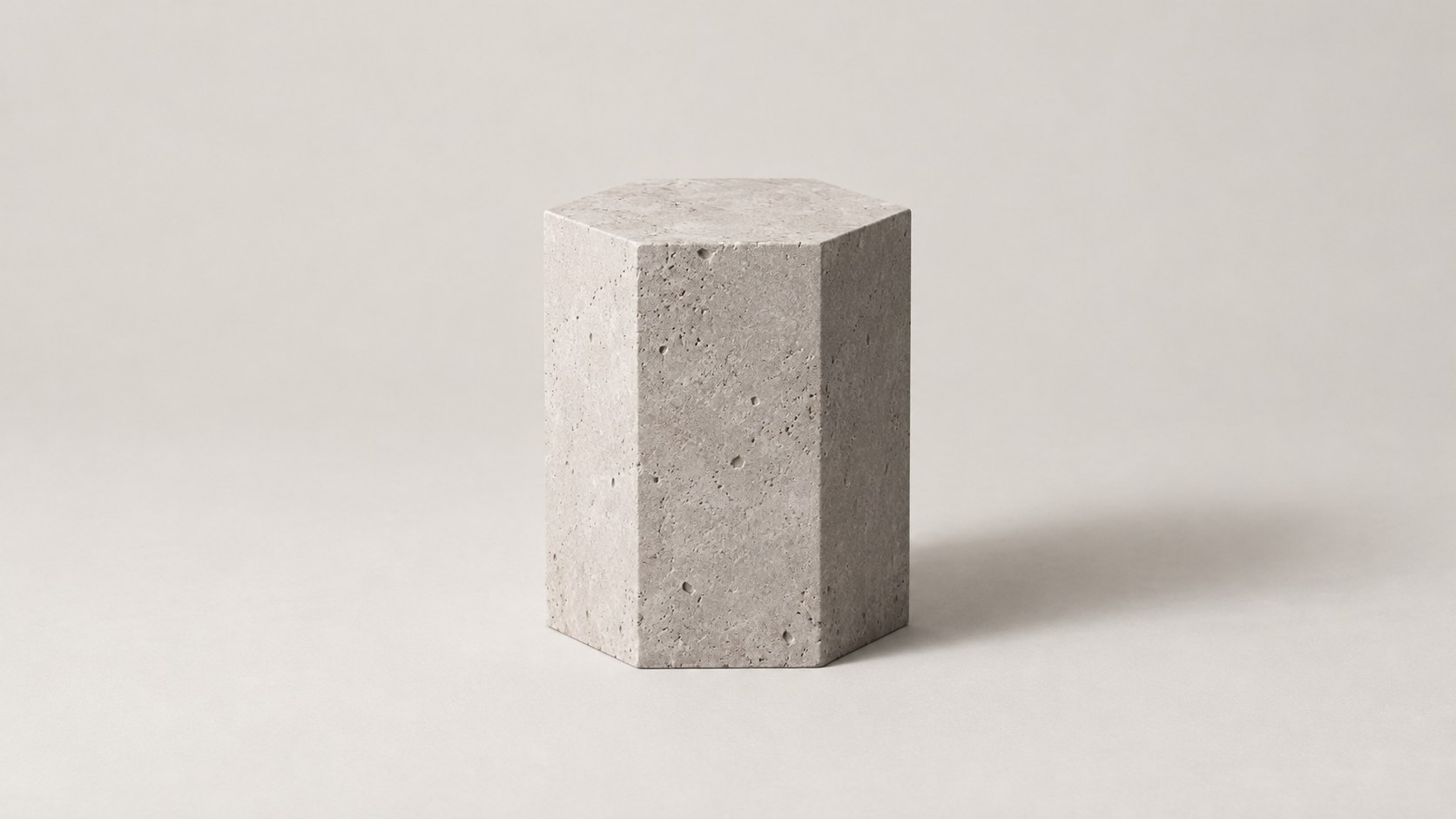 A pale hexagonal stone block on a soft cream ground.